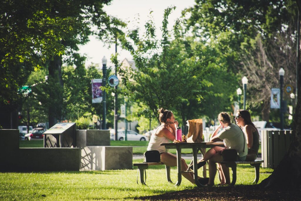 three women sitting on benches