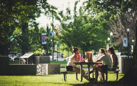 three women sitting on benches