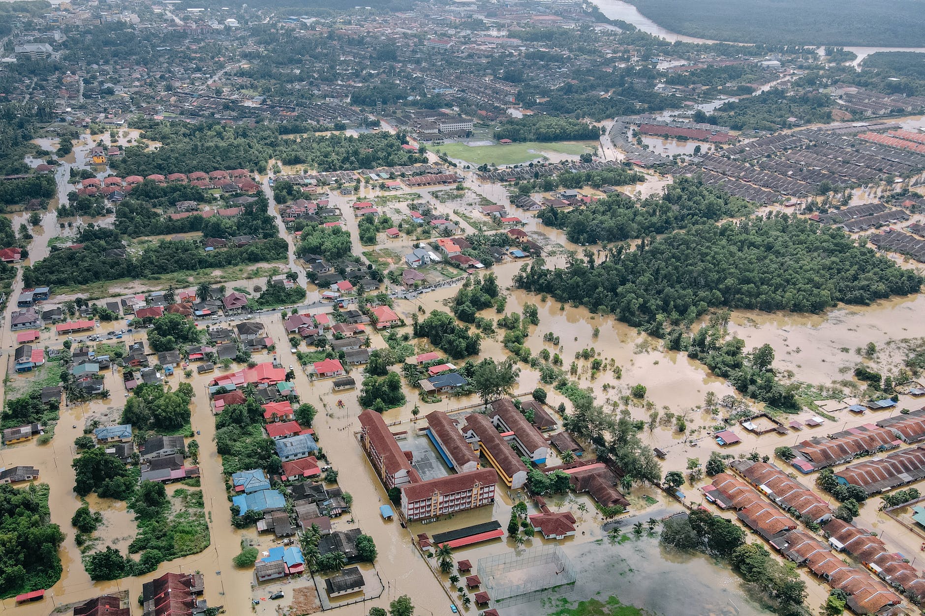 flooded town with residential buildings and trees