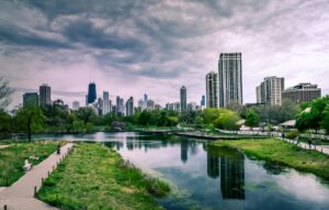 river near city buildings under cloudy sky